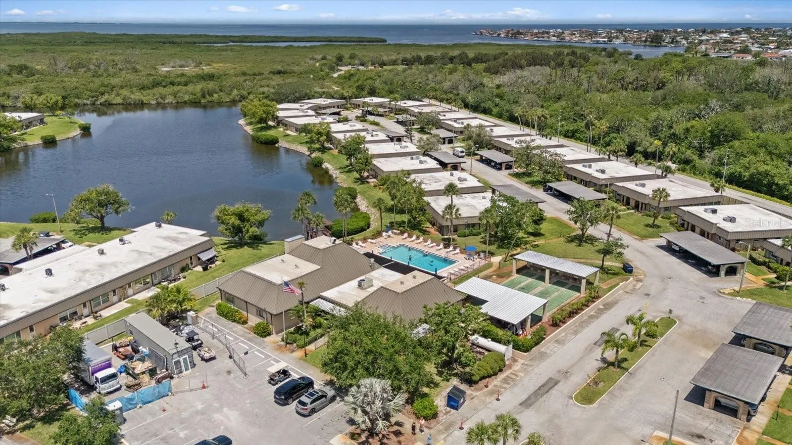 Aerial view of pool and courts with Gulf of America nearby Anclote park