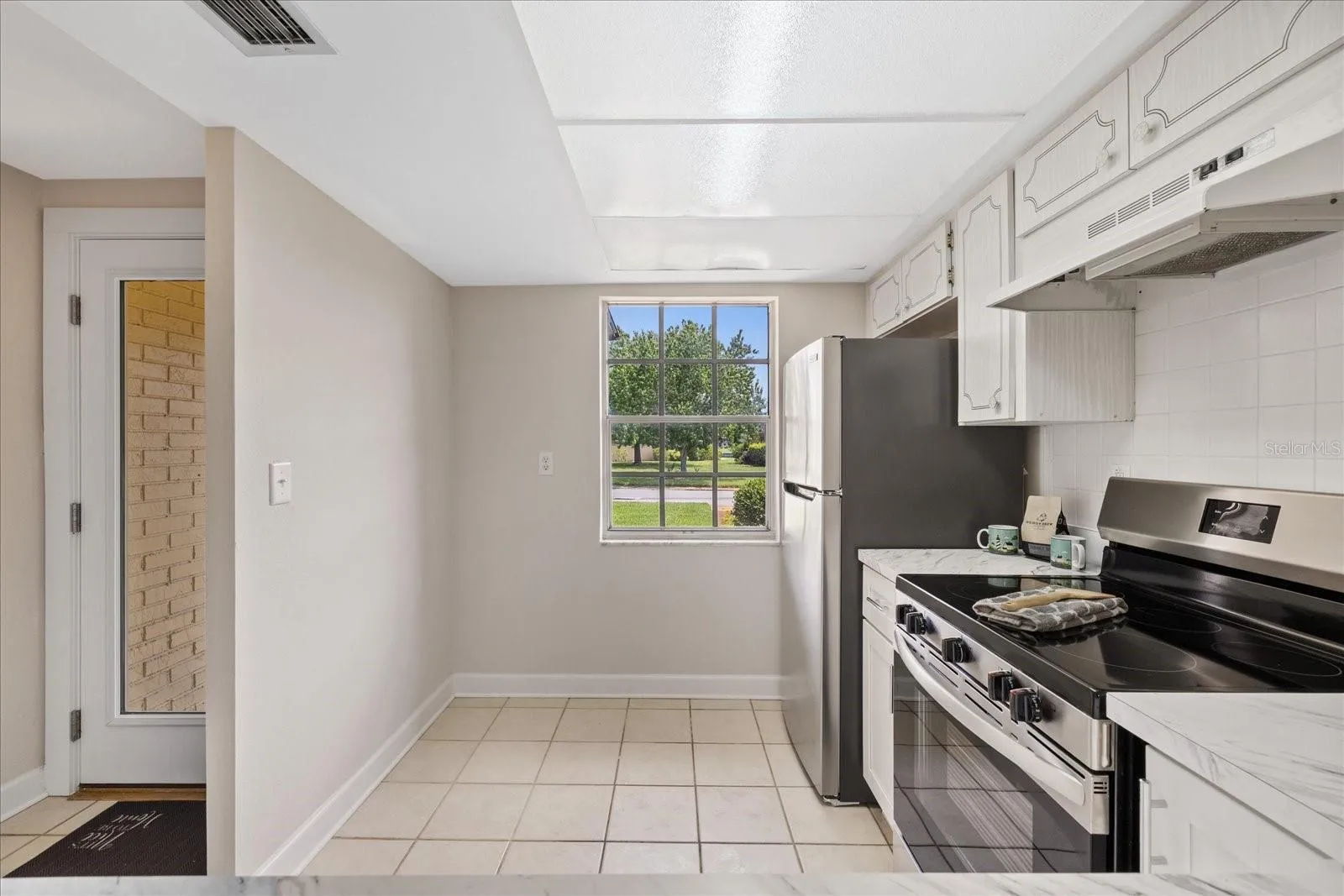 Front yard views from kitchen for breakfast table/bar area on left- new range and refrigerator
