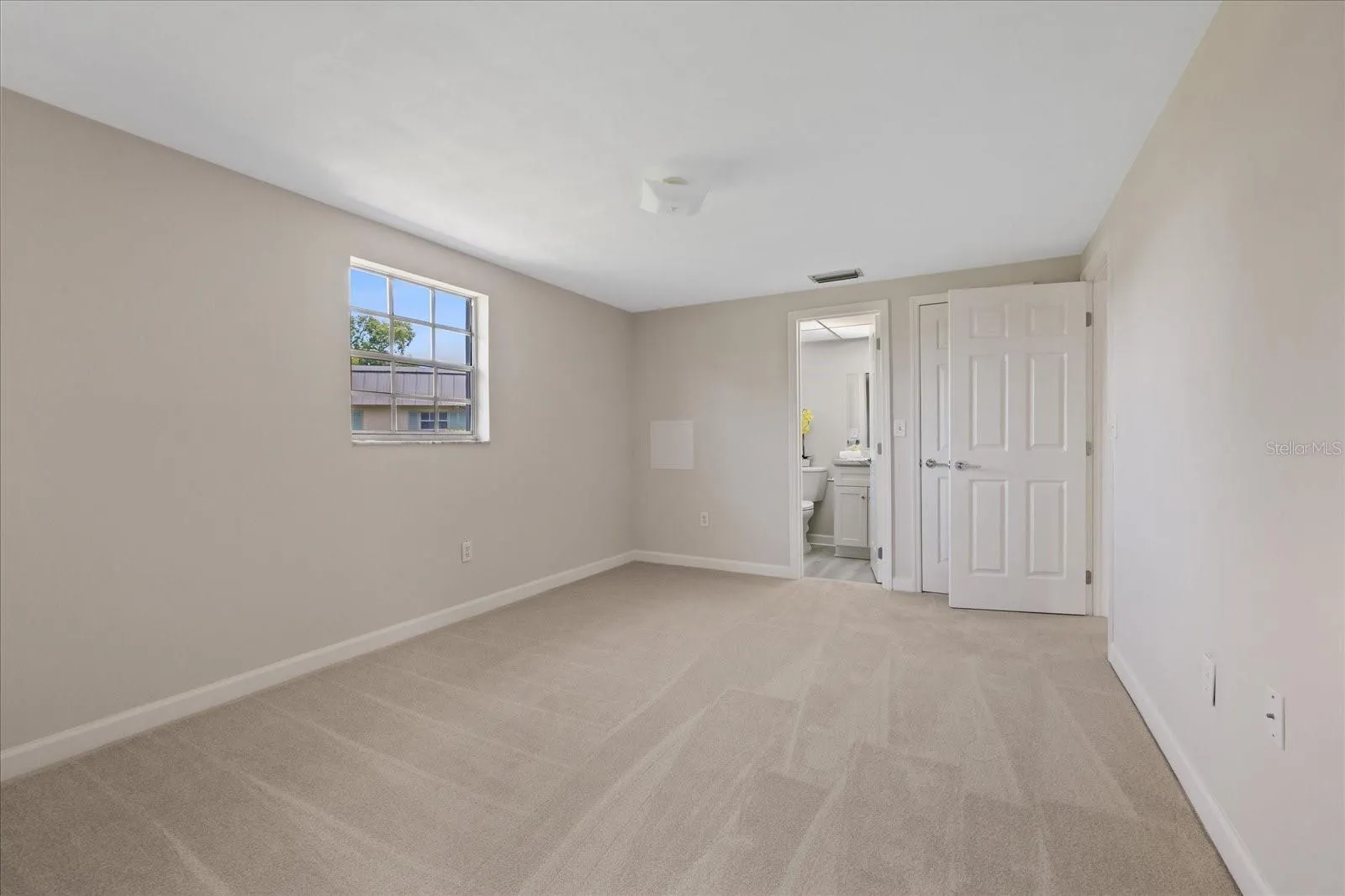 Primary bedroom with ensuite bathroom and walk in closet