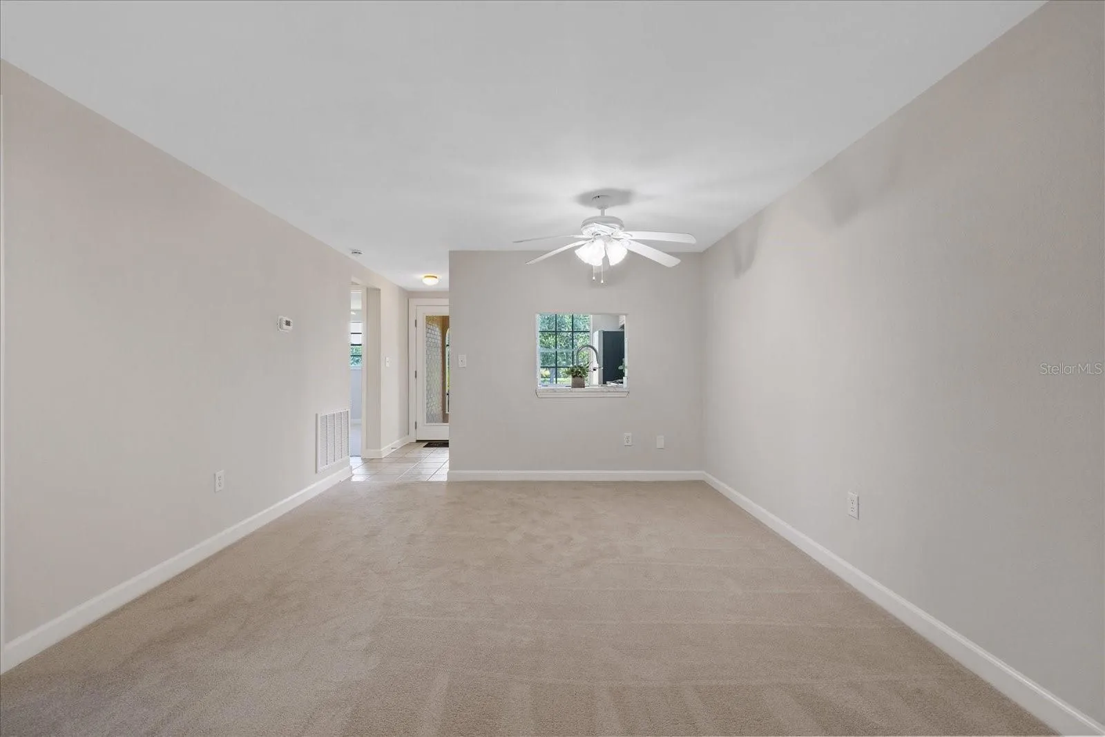 Living room looking toward kitchen and entry