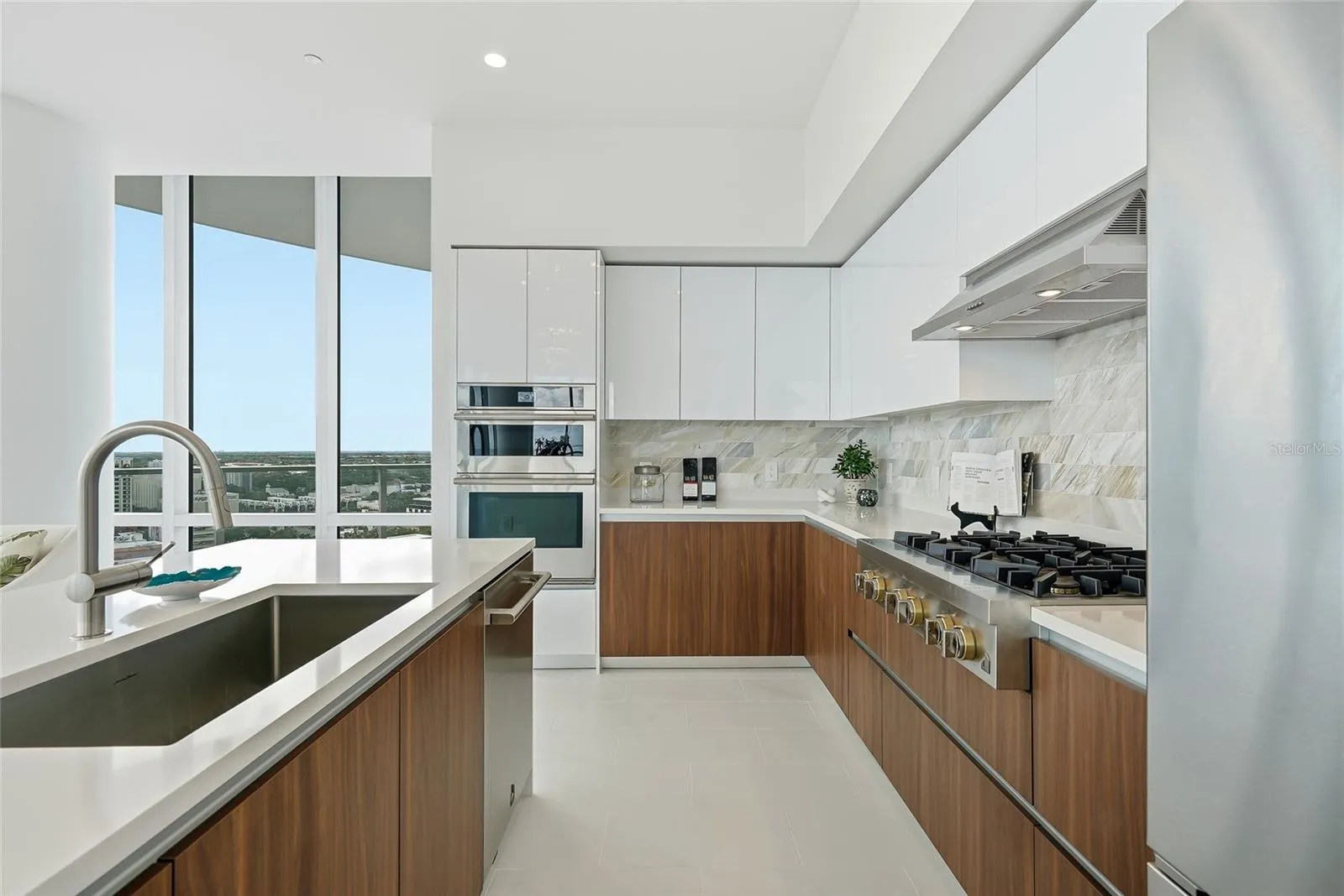 Premium JennAir appliances, contemporary cabinetry, and a generous gathering island.
