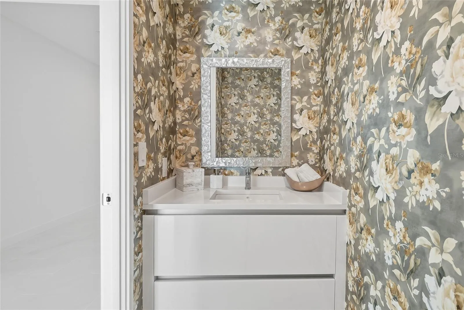 Convenient half bath near the kitchen and living areas, perfect for guests.