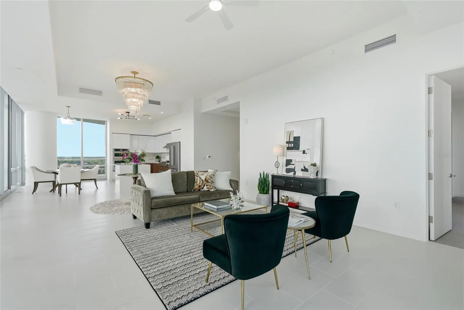 Open-concept living space. The door to the right leads to the primary suite.
