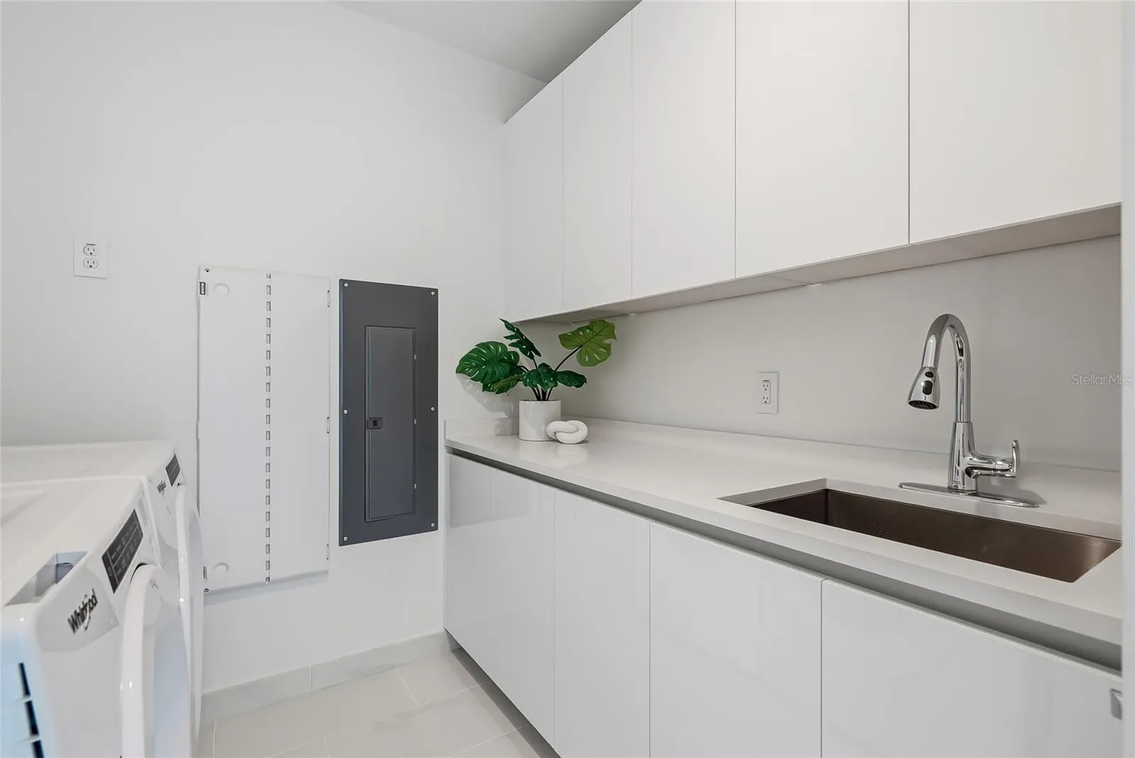 Convenient full-size washer and dryer in a dedicated laundry room.