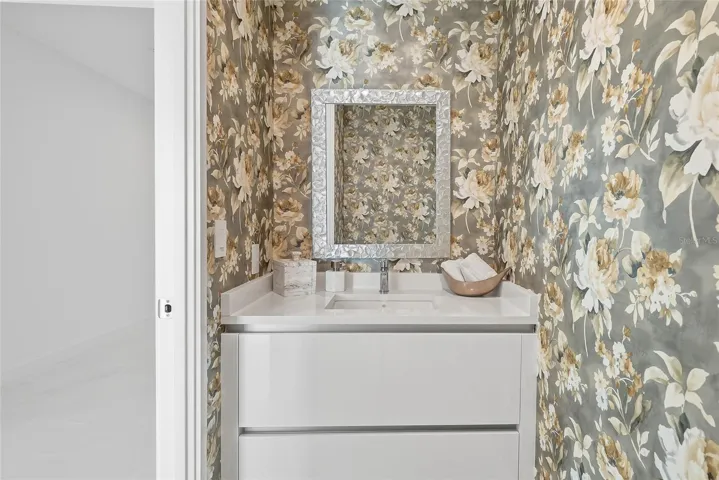 Convenient half bath near the kitchen and living areas, perfect for guests.