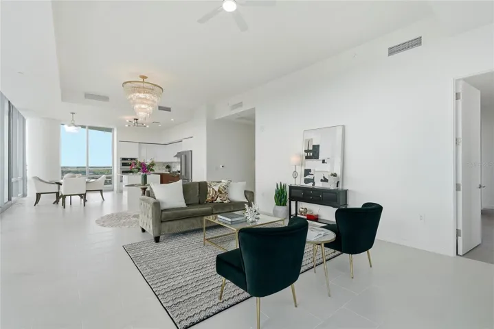 Open-concept living space. The door to the right leads to the primary suite.