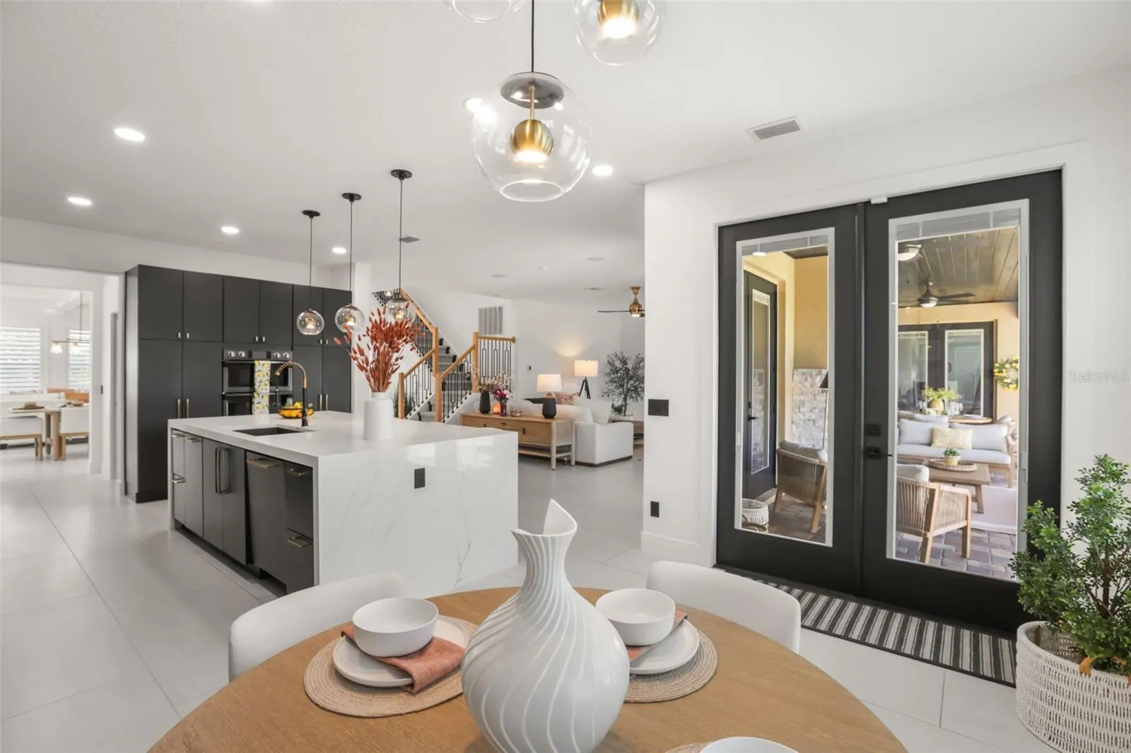 This dining nook sits just off the kitchen with direct access to the covered outdoor living area, creating a natural indoor-outdoor flow.