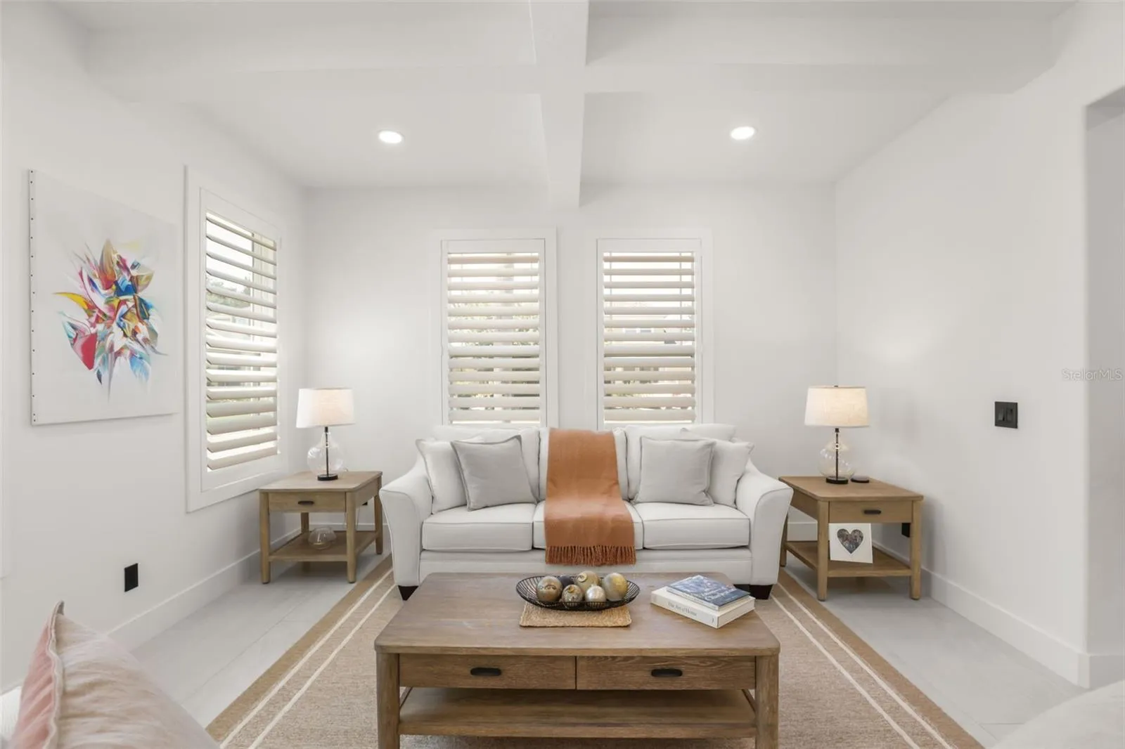 A cozy seating arrangement, layered textures, and clean-lined finishes create a polished living area ideal for conversation or quiet relaxation.