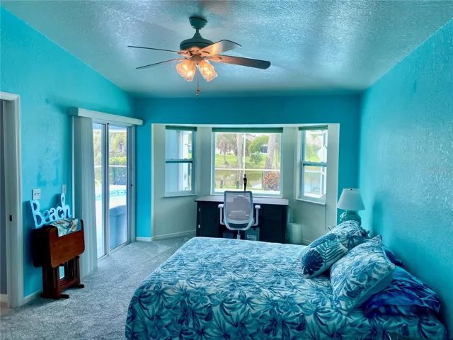 Sliders going to the pool from the master bedroom