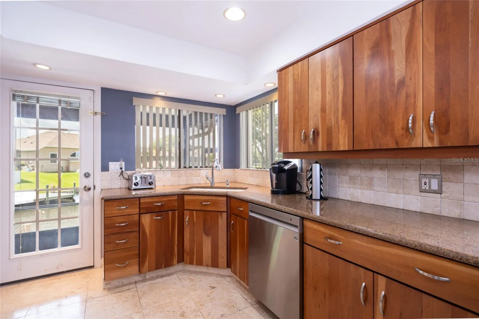 Door From Kitchen Opens Into The Screened Patio