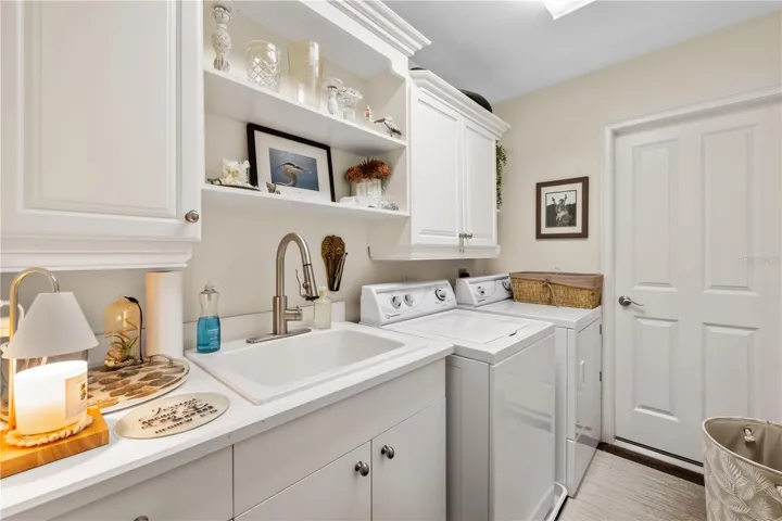 Laundry room with cabinets, shelves and wash basin