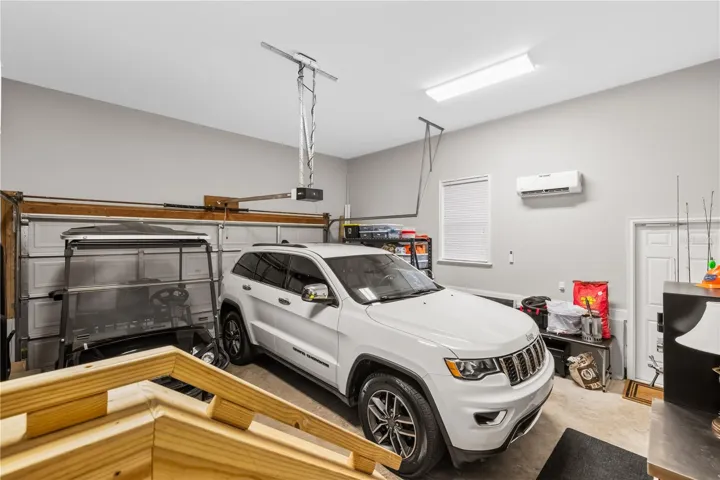 Garage with mini split cooling system, plenty of room for extra storage, side door...