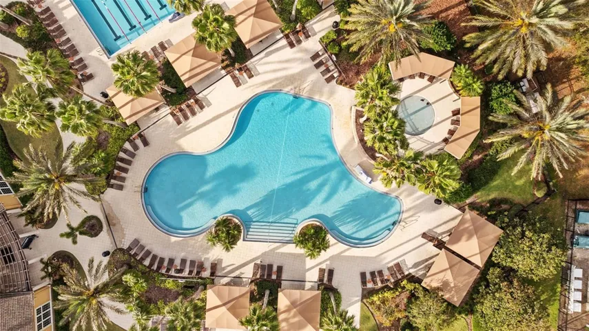 View of pool, cabanas, and hot tub