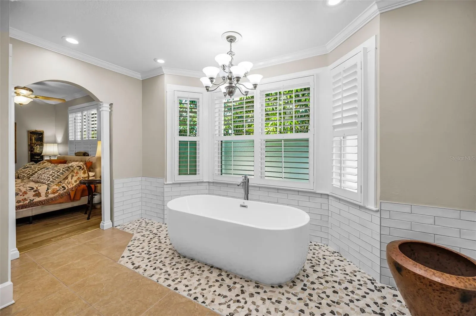 Stand-alone-tub, surrounded by bay windows.