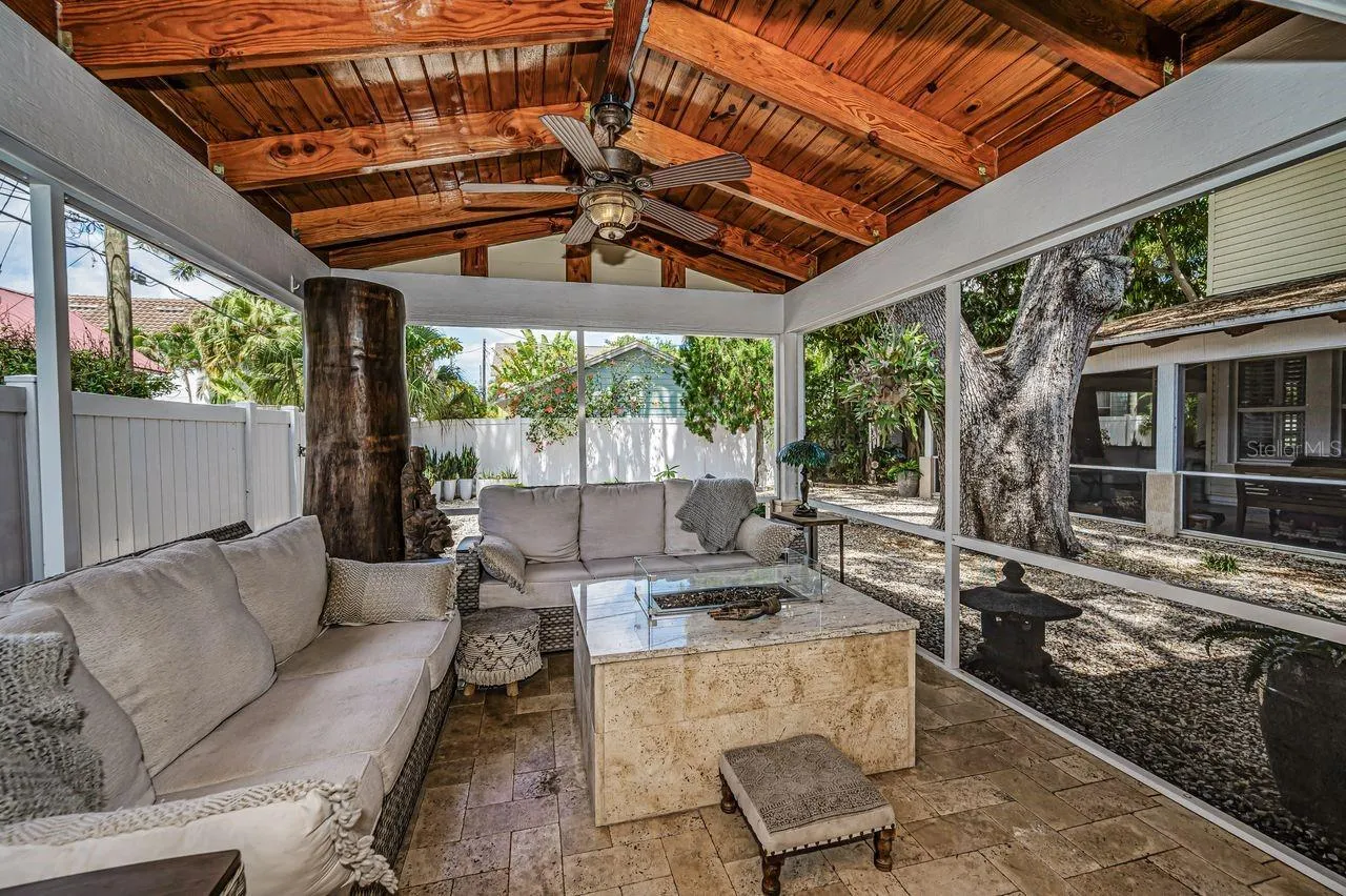 A space to relax around a gas firepit. Feels international, inviting, and beautifully framed