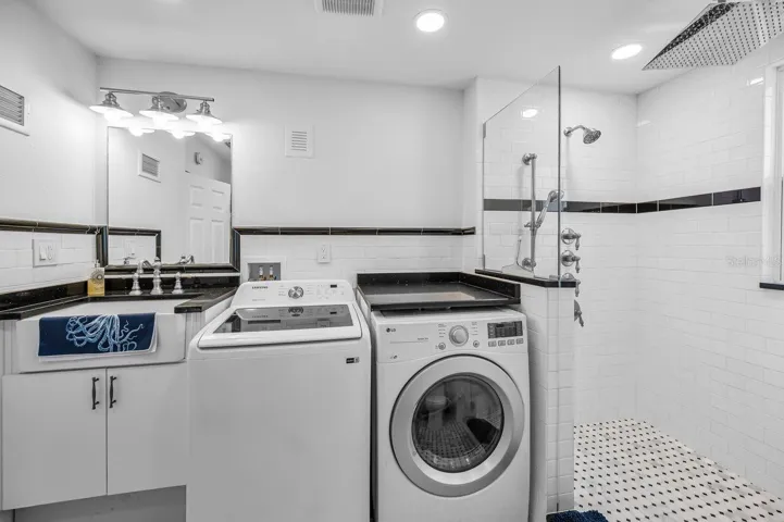 Upstairs laundry room with a full guest bath.