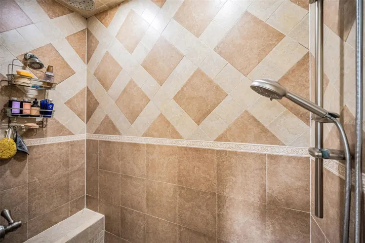 Shower with built in bench and steam room.