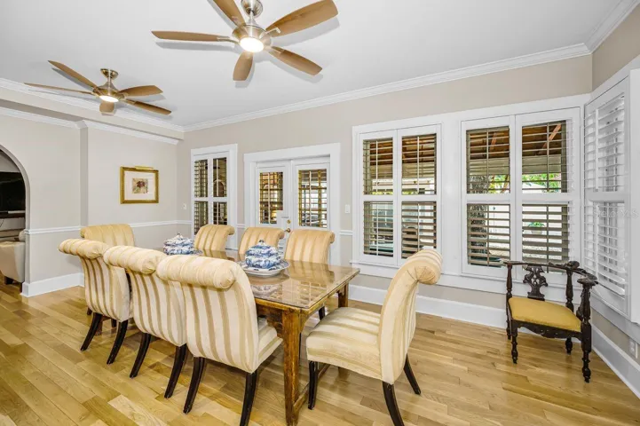 Dining room surrounded by windows creates a sunroom effect.