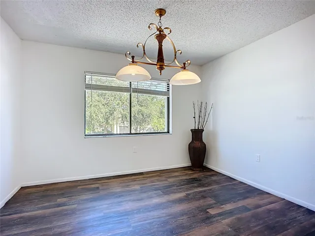 Another view of the dining room and easy to maintain luxury vinyl plank flooring.