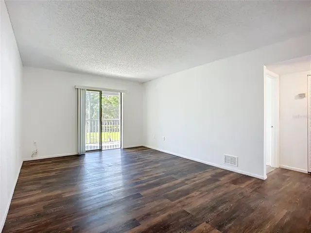 Great room with sliding door to the screened balcony.