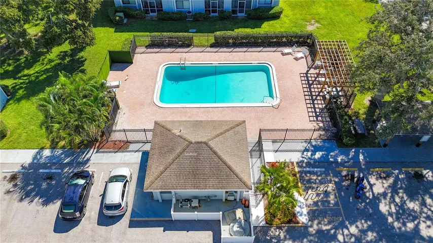 Aerial of the community pool and clubhouse with a fitness center.