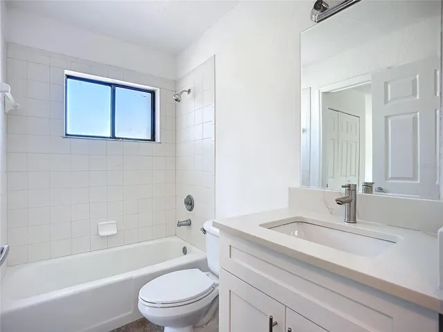Ensuite bathroom with newer toilet, cabinet and vanity.