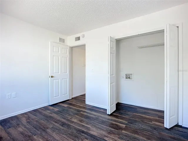 Guest bedroom with washer and dryer hook ups.