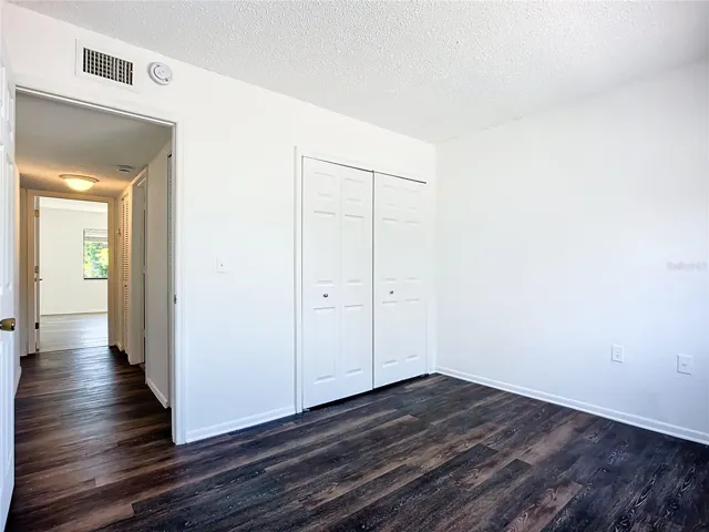 Guest bedroom with washer and dryer hook ups in the closet.