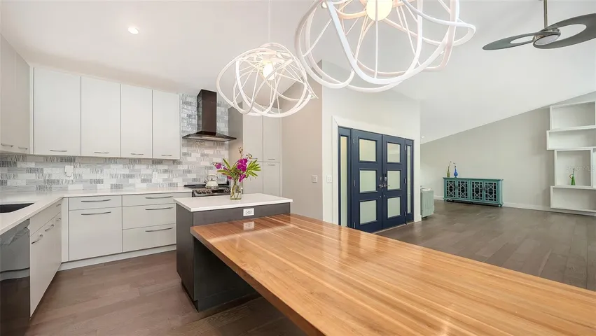 Oversized island and custom dining table create the perfect gathering space.