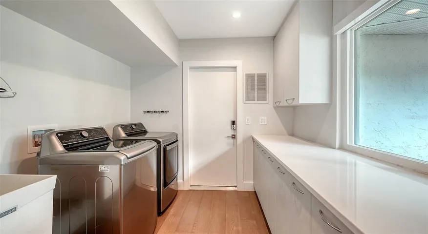 Functional laundry room with ample storage.