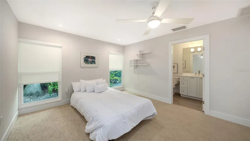 Generous guest bedroom with abundant natural light.