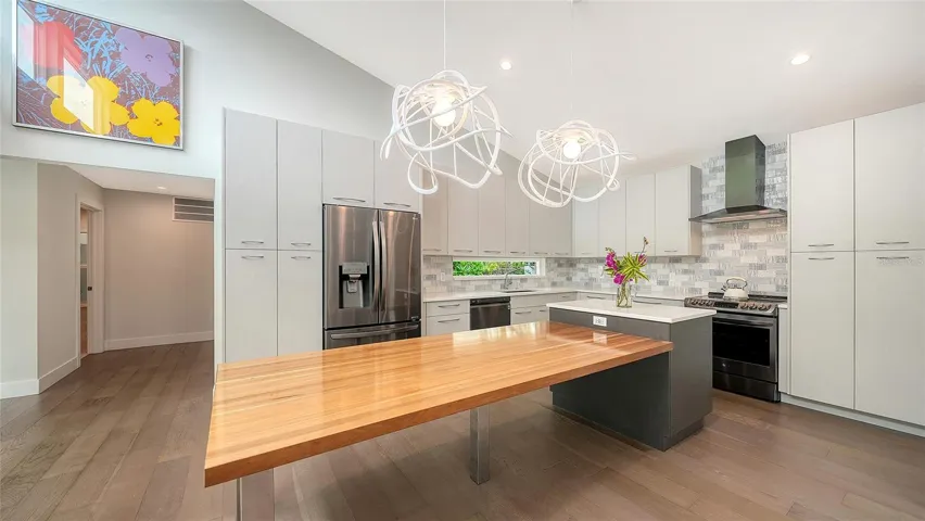 Designer kitchen with quartz countertops and custom cabinetry.