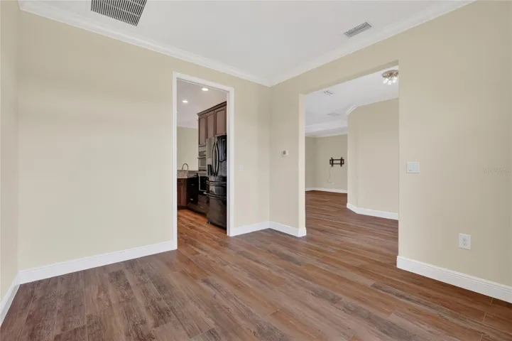 View of dining area open to foyer and kitchen ~