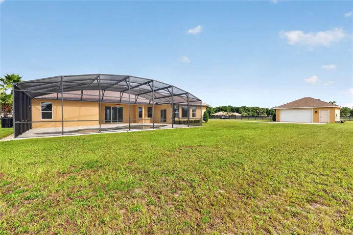 Great use of space on this homesite ~ oversized detached garage or workshop with drive access ~