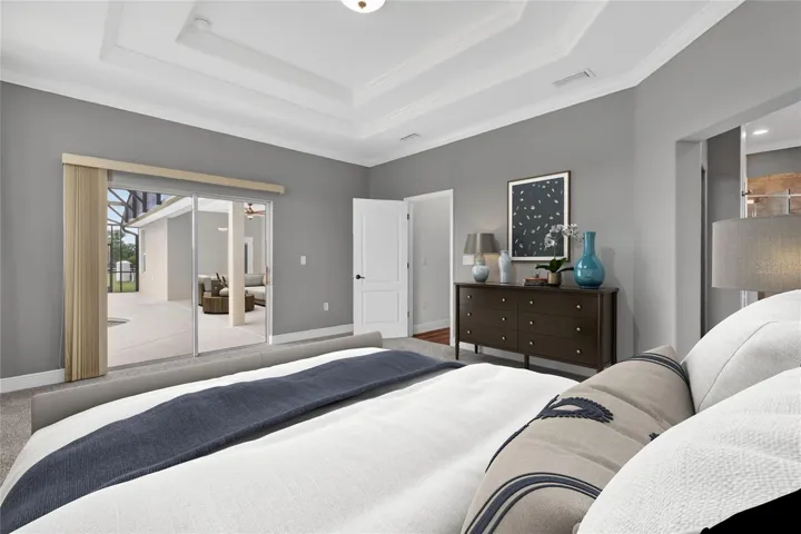 Virtually staged primary suite - doors out to lanai ~