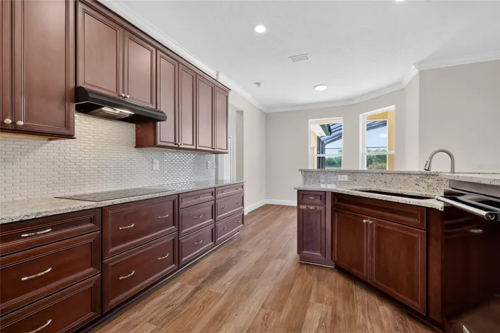Wellborn soft close cabinetry; gleaming granite counters ~