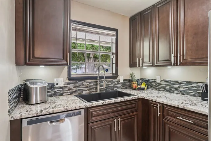 Deep Single bowl kitchen sink, Underlight cabinetry with hardware, backsplash