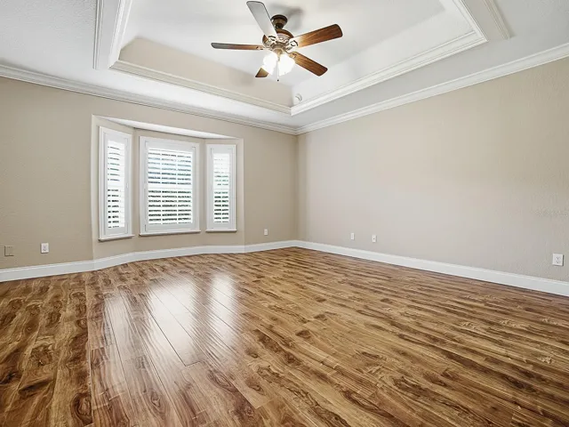 Primary Bedroom with Tray Ceiling & Crown Molding.