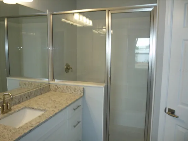 Vanity with large enclosed shower.