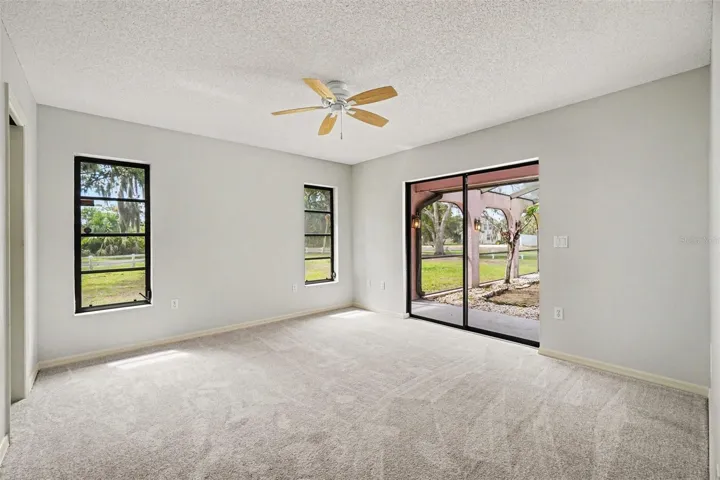 Bedroom 3 with walk-in closet and sliding glass doors to the lanai