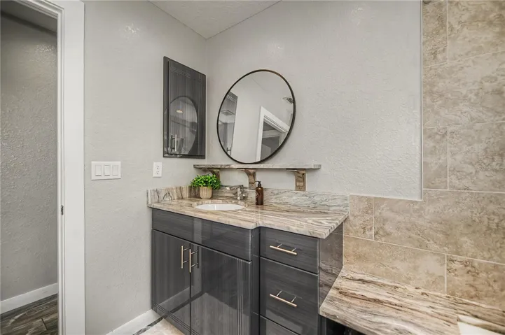 Modern Guest Bath with Stylish Vanity, Stone Countertops, and Designer Finishes.