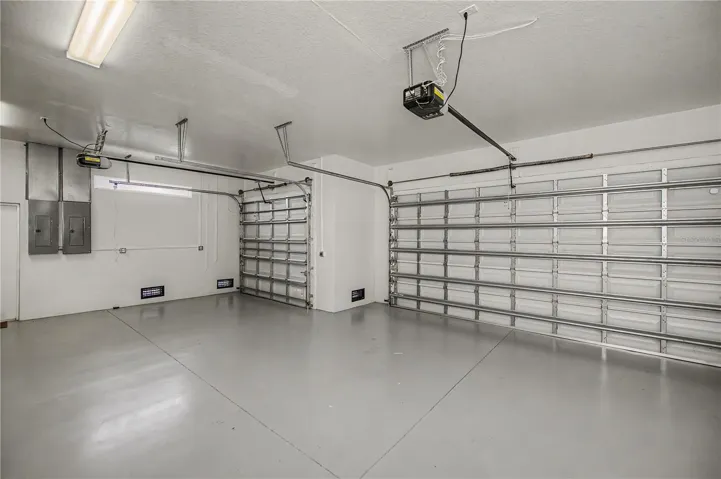 Oversized 3-Car Garage with Epoxy Floors and Ample Storage Space.