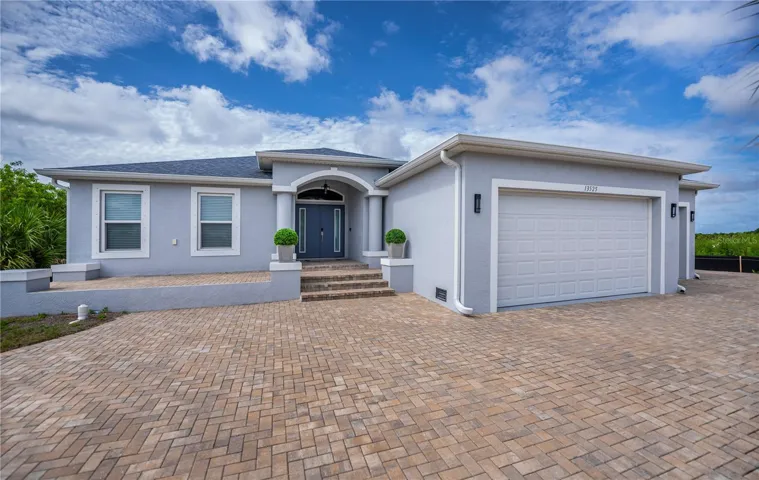 Impressive Curb Appeal with a Paver Circular Driveway, Grand Entry, and Oversized 3 Car Garage.