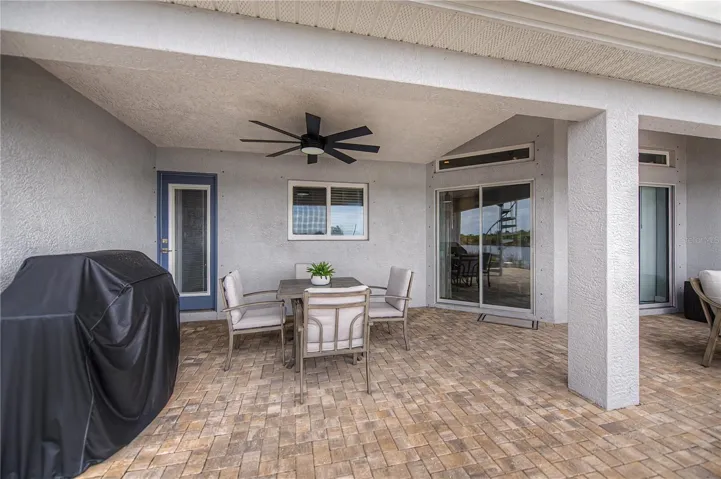 Covered Waterfront Patio with Paver Flooring, Outdoor Dining Space.