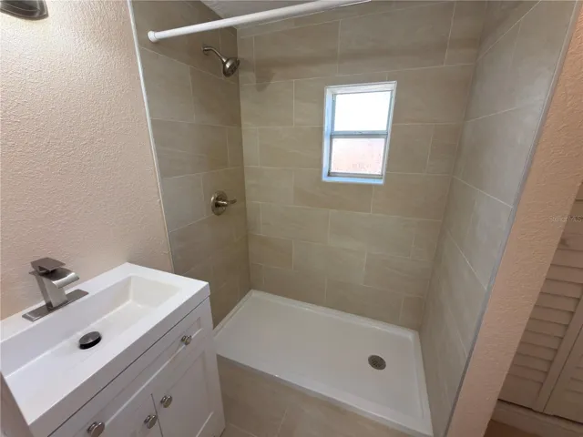 Bathroom with walk in shower and custom tiled