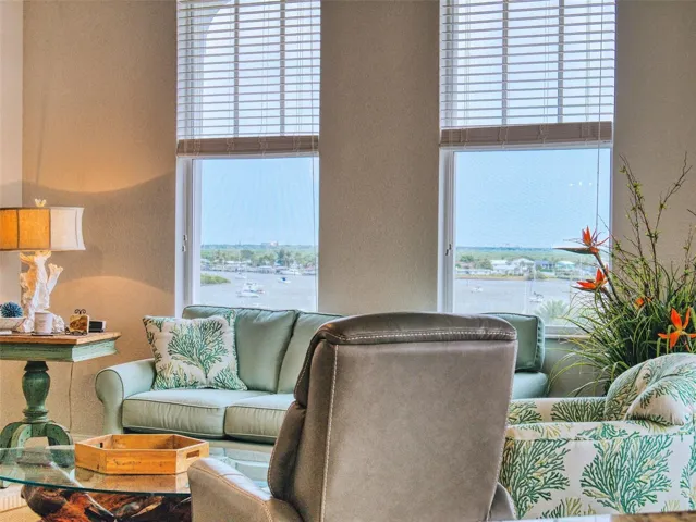 Living Room with view through the front windows of the marina