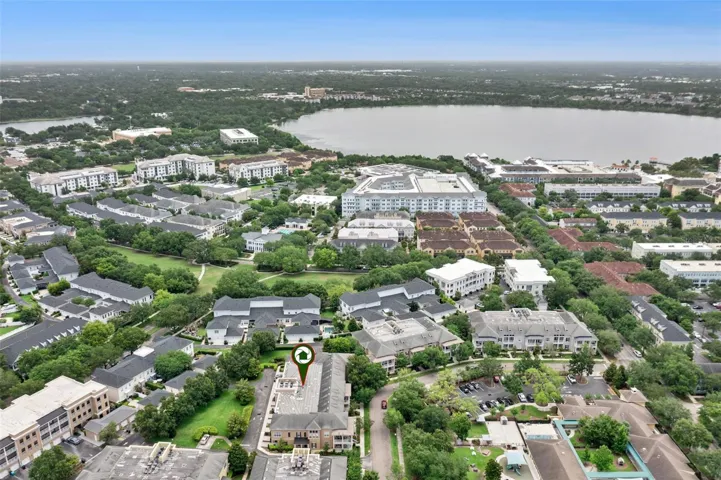 Condo building and view towards Corrine Commons and Grace Hopper Hall and Lake Baldwin. Baldwin Park City Center on right side of frame.
