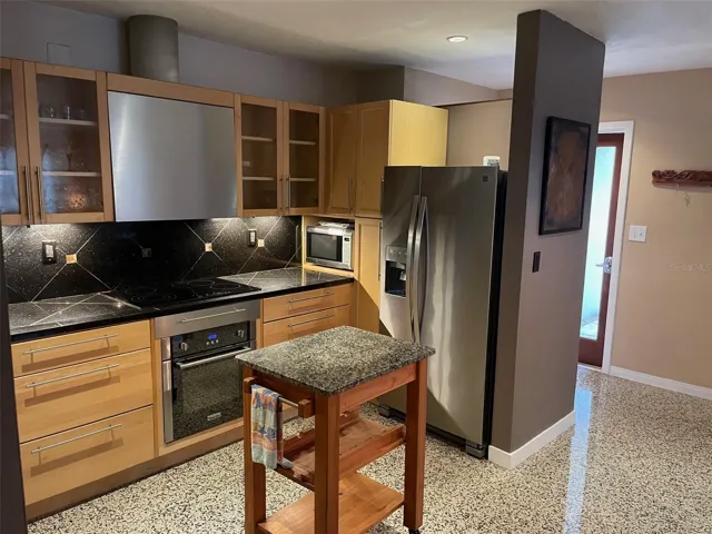 Kitchen. Solid Maple Cabinet Faces, Granite Countertops and Stainless Steel Appliances.