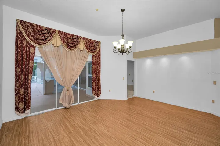 Formal Living Room With Access To The Kitchen & Screened-In Lanai