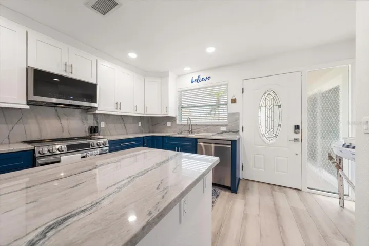 Custom cabinets and granite backsplash work so well together